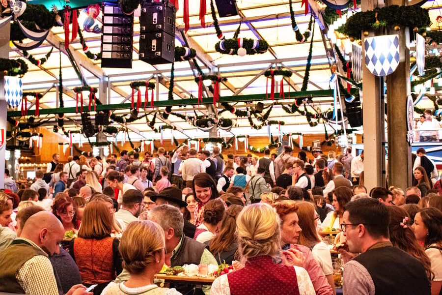Munich: Oktoberfest Tour with Tent Reservation, Food & Beer - Singing, toasting, and meeting people at the table